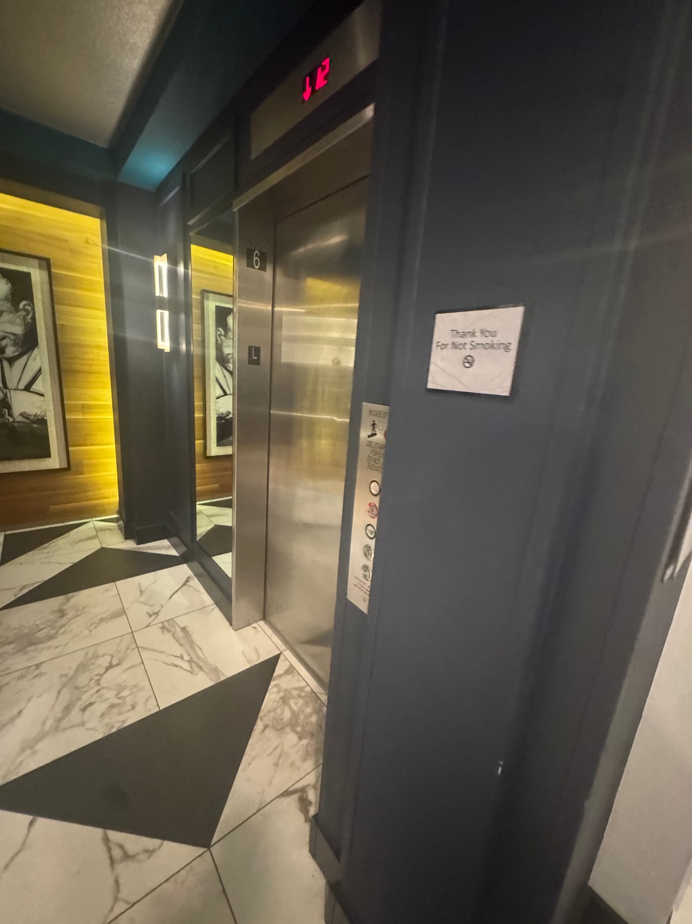 The elevator and marble hallway