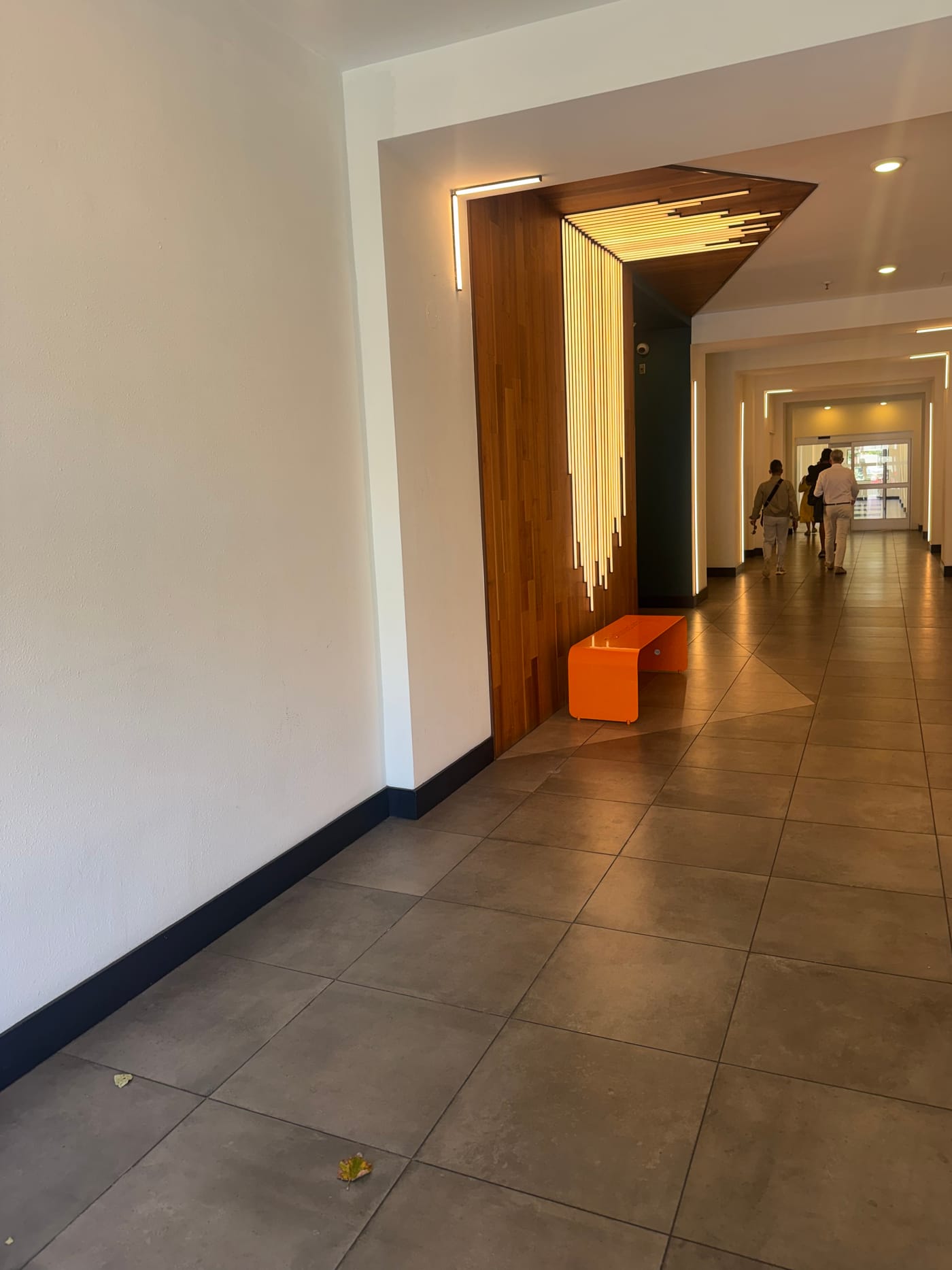The lobby with warm wood-slat lighting